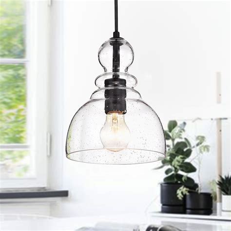 Offered in two shapes, whether alone or in a grouping,. . Matte black glass pendant light